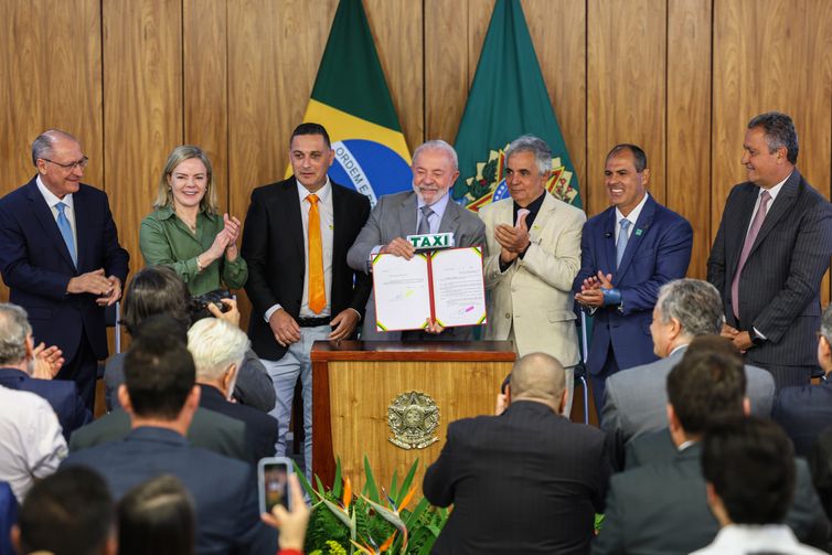 Valter Campanato/Agência Brasil Brasília (DF), 14/07/2025 - Presidente Luiz Inácio Lula da Silva (c), participa da assinatura de medida provisória que concede isenção da taxa de serviço metrológico para verificação de taxímetros
Foto: Valter Campanato/Agência Brasil