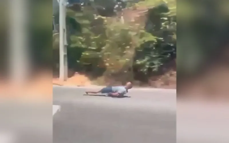 Homem desce deitado em skate no meio do trânsito em Manaus